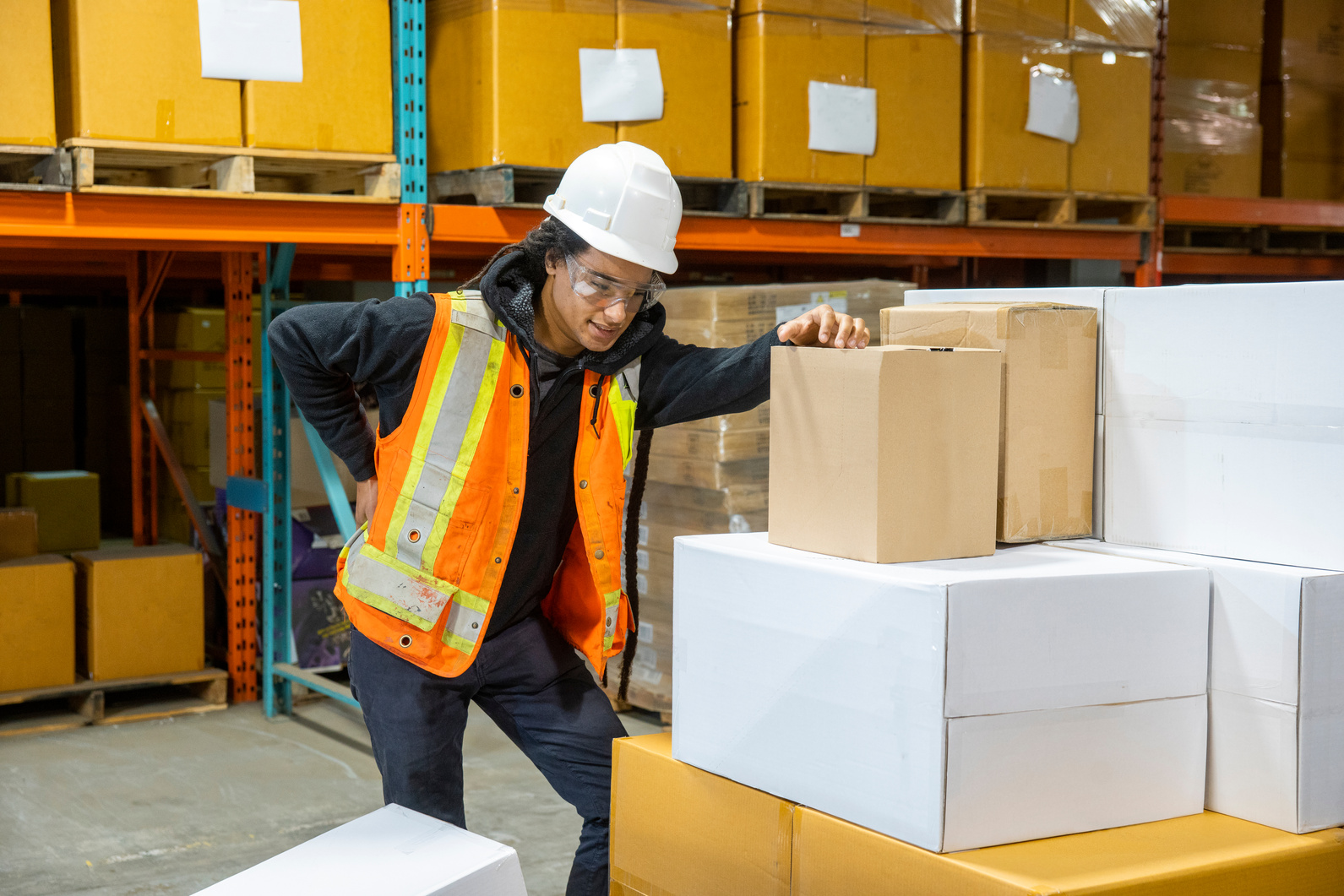 A man experiencing back pain at work